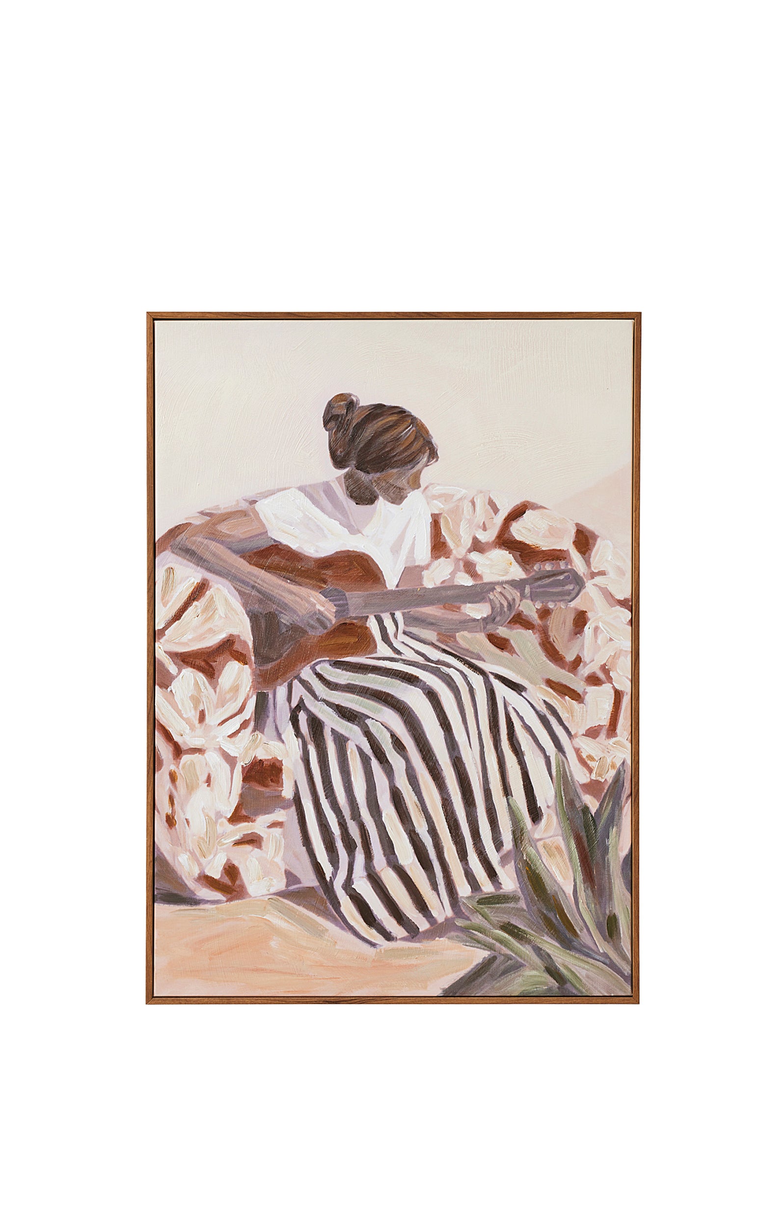 A framed oil painting of a woman with her hair in a bun, seen from behind, playing a guitar while seated in a floral armchair, wearing a white blouse and black and white striped skirt, with a green agave plant in the foreground.