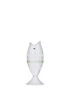 A small clear ribbed glass vase shaped like a fish, with a tail-fin base, a black glass eye and wavy ivory and green trim bands around the body.