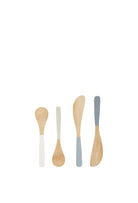 A set of four bamboo utensils with coloured dipped handles in white, sage, grey and charcoal - two round-bowl spoons and two flat spreader knives, arranged in a row.